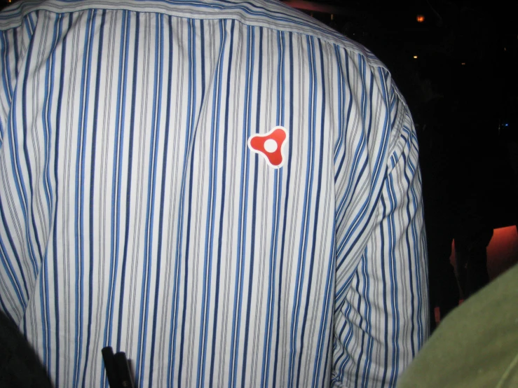 a blue and white striped shirt with a heart in the chest