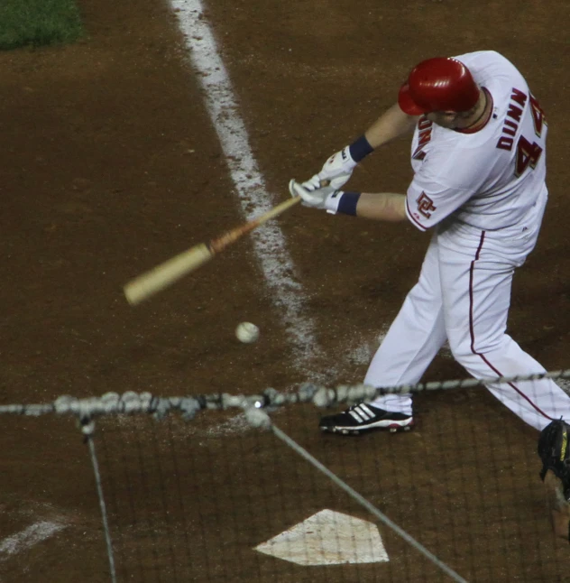 a baseball player swinging a bat at home plate