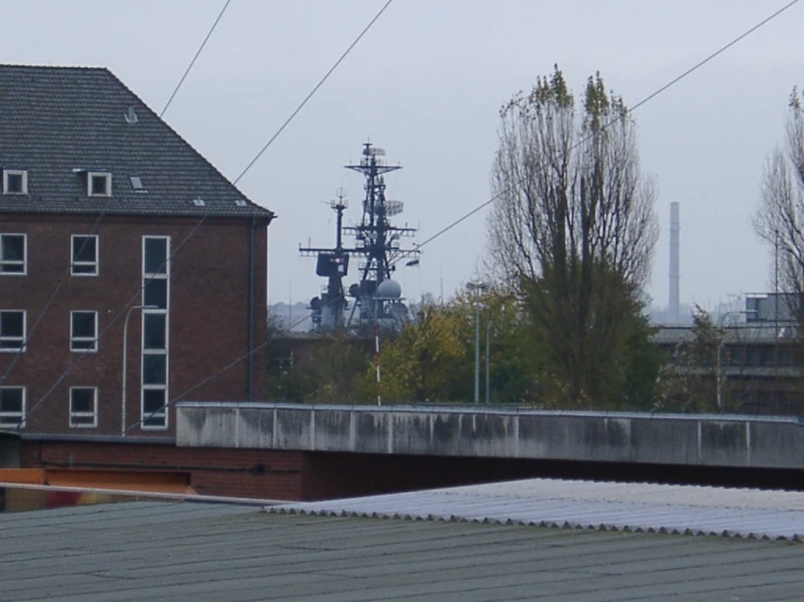 a train station on the tracks in front of a brown building