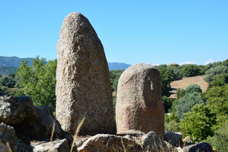 there are three huge rock like sculptures on the hills
