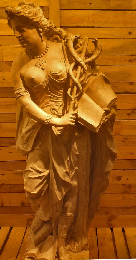 a statue of a woman with a snake on her arm