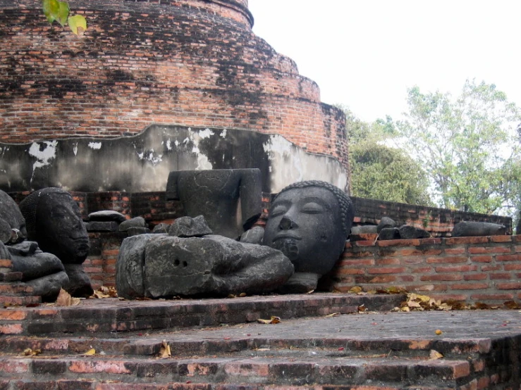 a statue that is on some steps by some trees