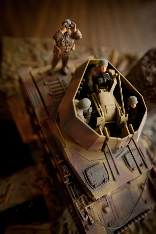 toy soldiers are riding on top of a tank