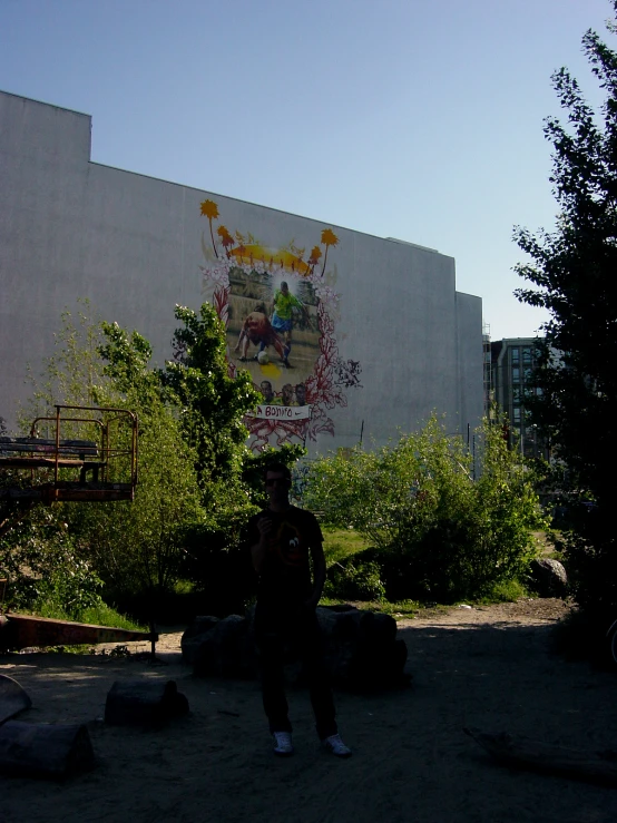 a man is sitting in front of an abandoned building