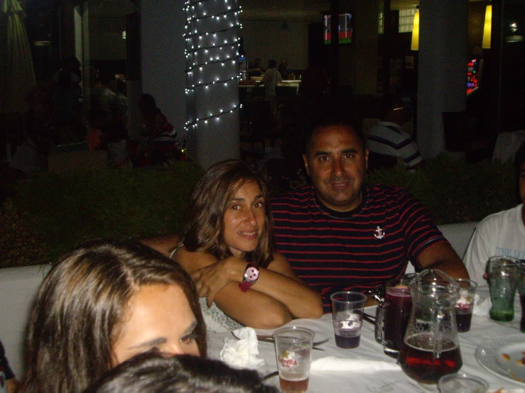 a group of people sitting around a table at a dinner