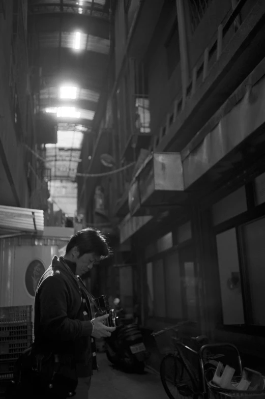 a man in a large warehouse working on machinery