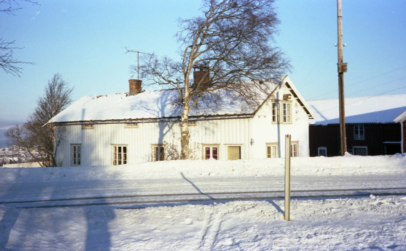 a large snow covered field next to a big building