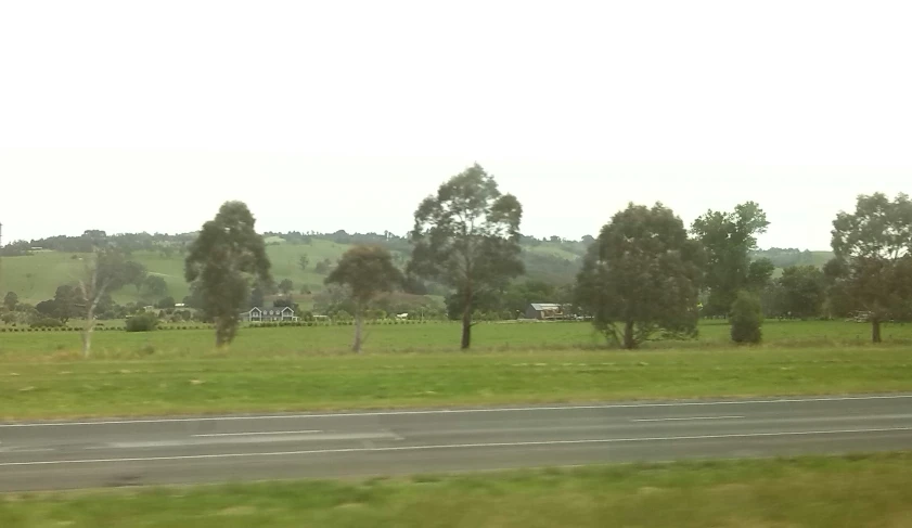 a rural view of the road and grass