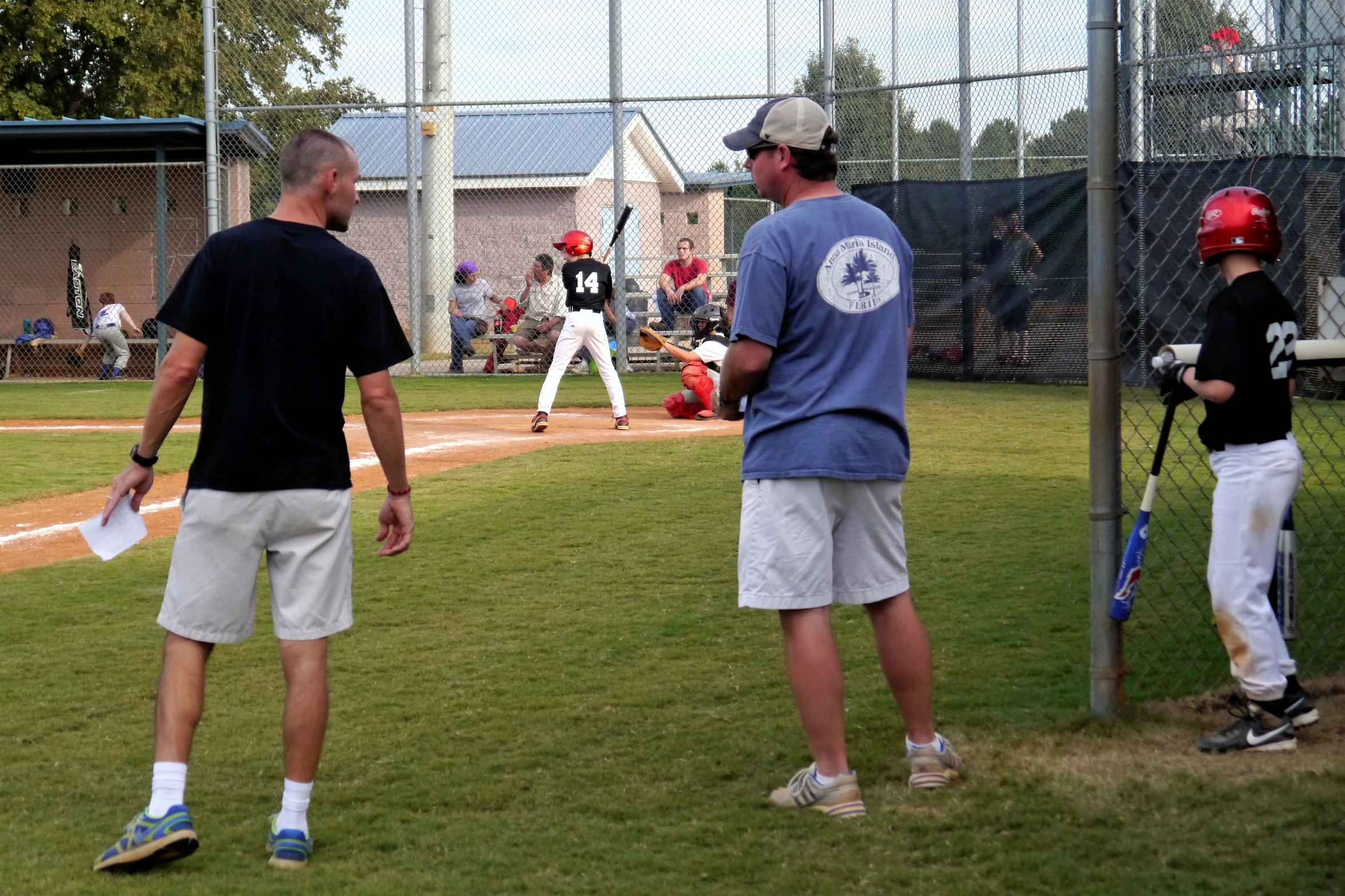 the young men are practicing playing baseball on the field