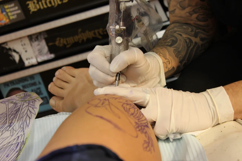 a woman getting tattoos done at a tattoo parlor
