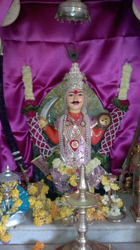 a statue on top of a stand surrounded by other decorations