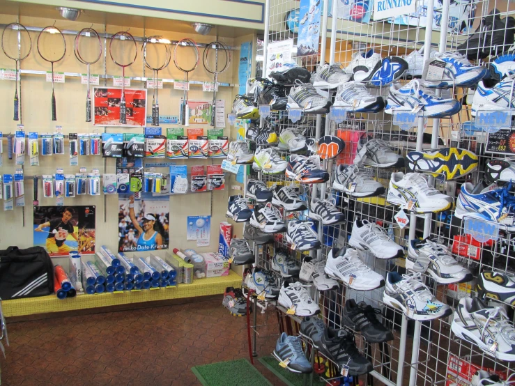 a store with a large number of shoes hanging on a wall