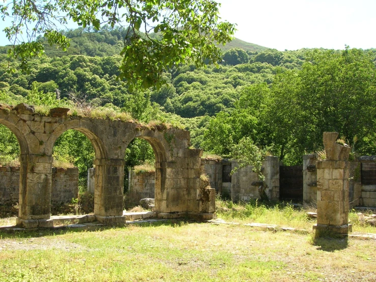 this old cemetery sits in front of a green hillside