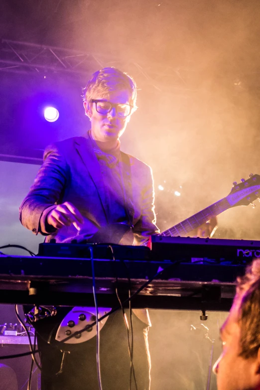 the man plays on his electric piano during a concert