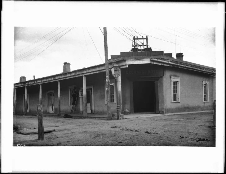 black and white pograph of an old house in a deserted area