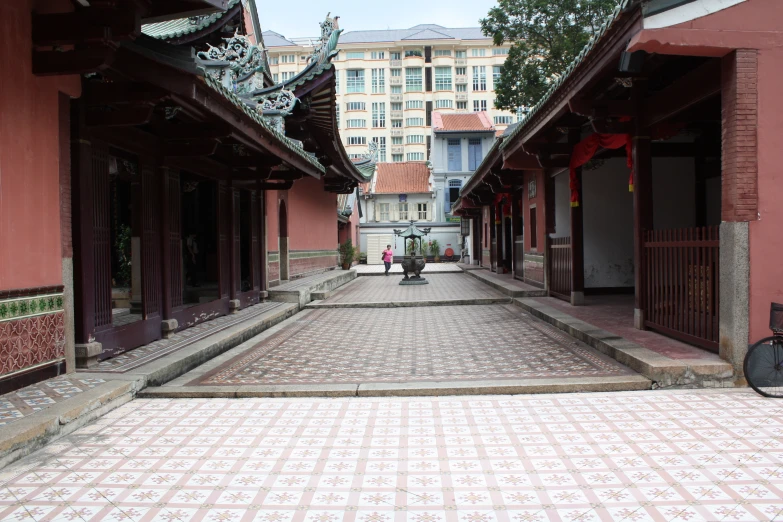 a narrow cobblestone street with buildings on both sides