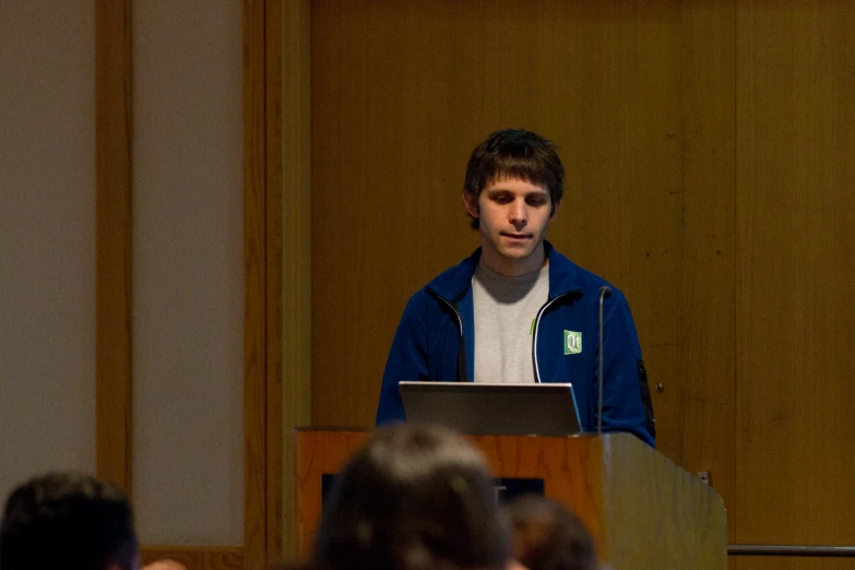 a man stands at a podium while speaking