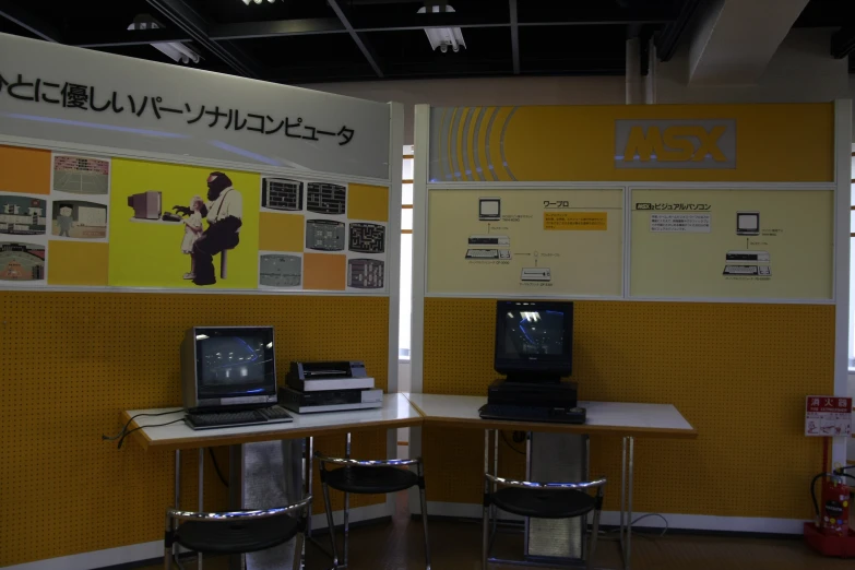 two small desks with computers sitting on them