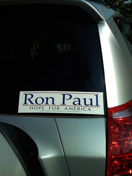 a car parked in a street near the word ron paul