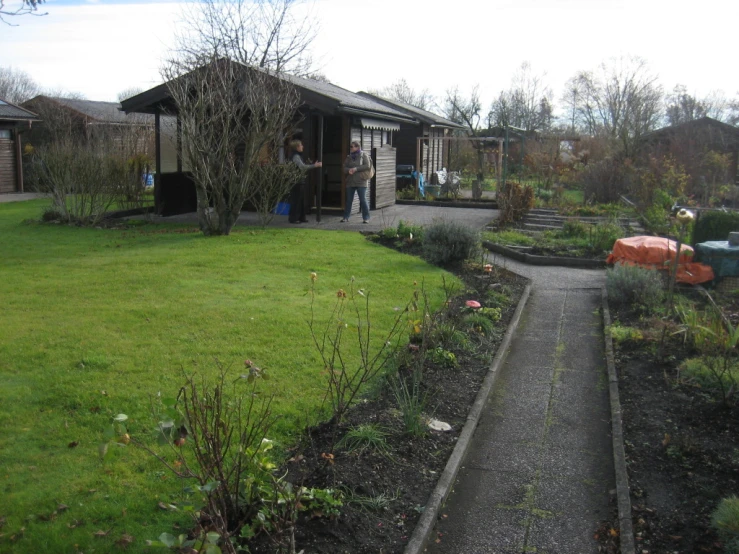 a house and some shrubs and some people