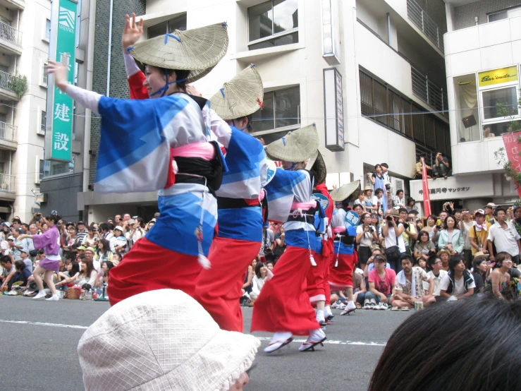 a group of people in traditional japanese attire in front of a crowd