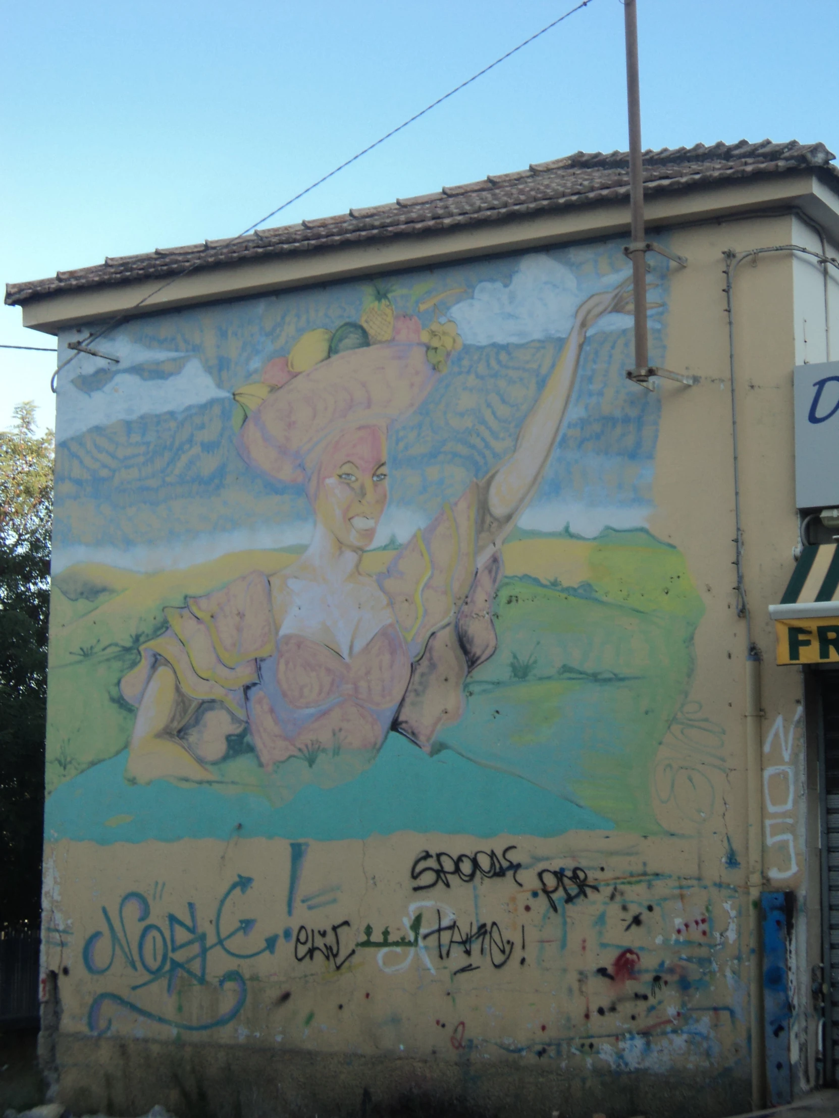 large wall painting with a woman holding up a hat