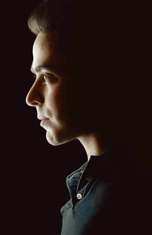 profile s of young man with dark background