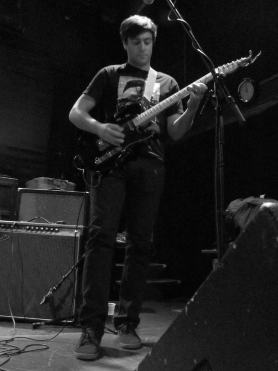 a person standing on stage with a guitar