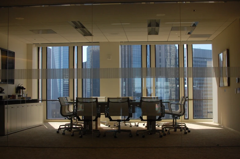 a conference table surrounded by chairs in an office