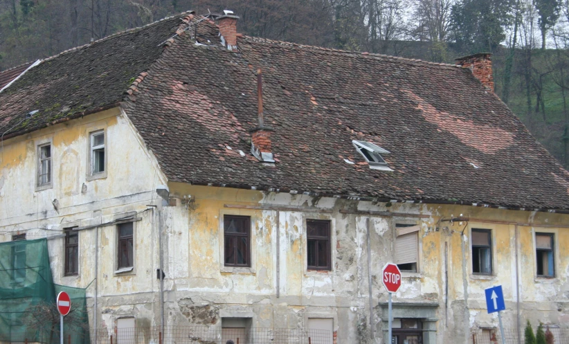 a rundown building with a broken down roof