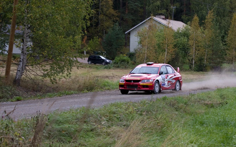 red racing car on a rural dirt road