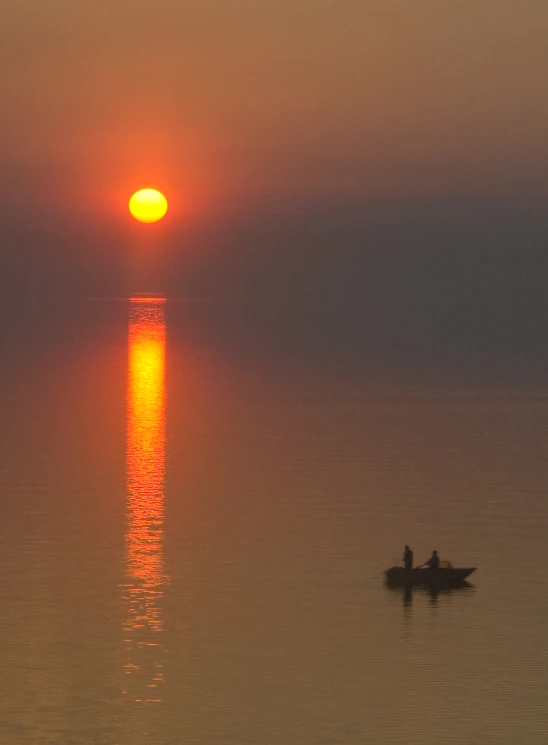 a couple of people in a small boat on the water