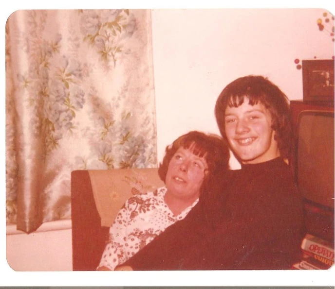 two people posing together in a living room