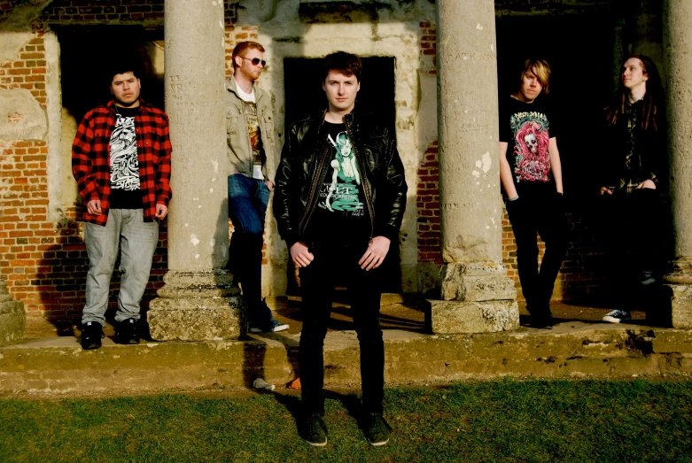 a group of men standing in front of an old building