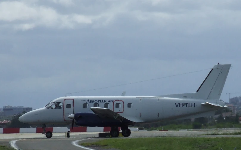 an airplane parked on the runway and in front of buildings