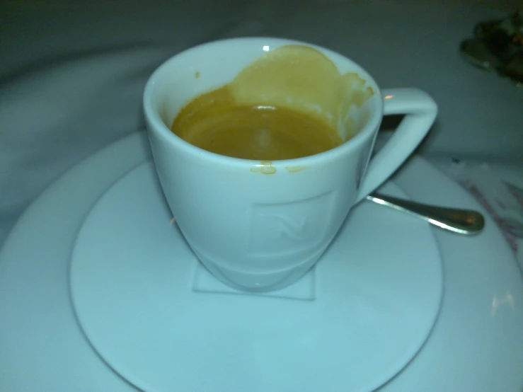 the coffee cup sits on a white plate