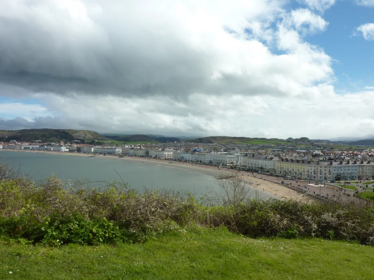 a view looking down on a town by the sea