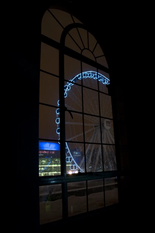 an amut park ferris wheel seen through an open window