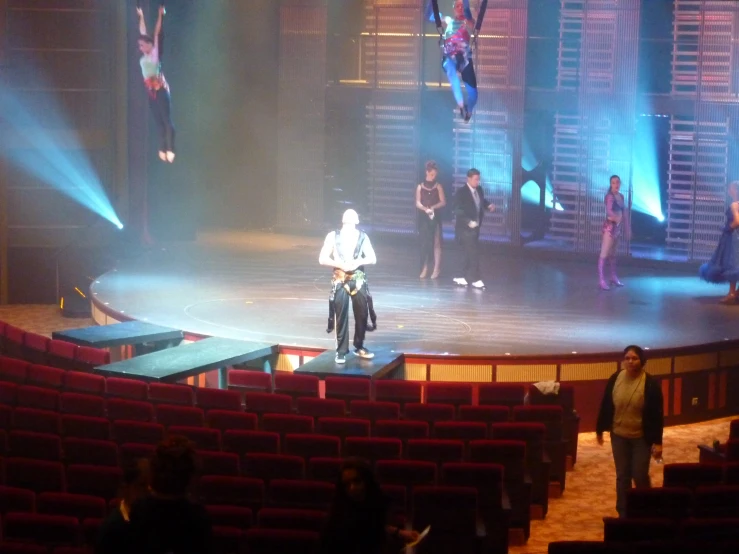 a person in white shirt performing on stage