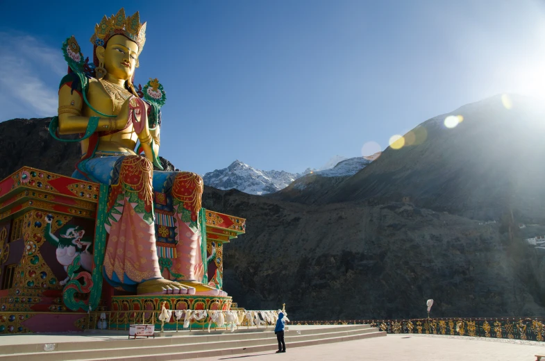 the giant buddha statue in the desert looks like a painting