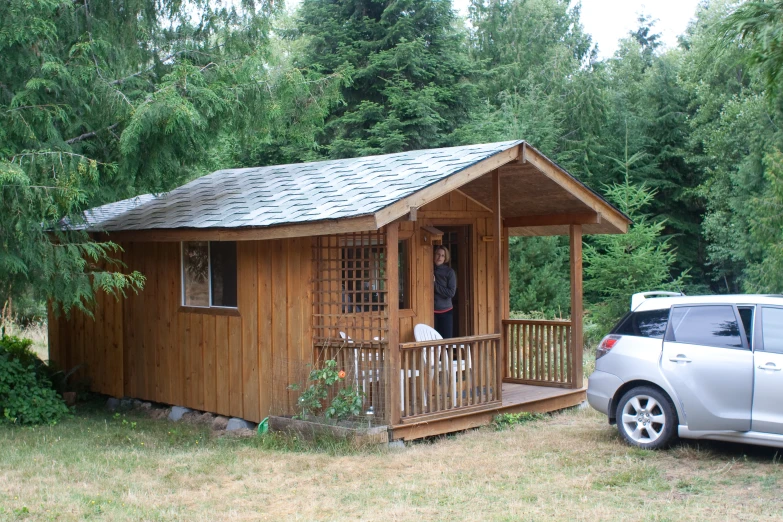 a car is parked outside a small house