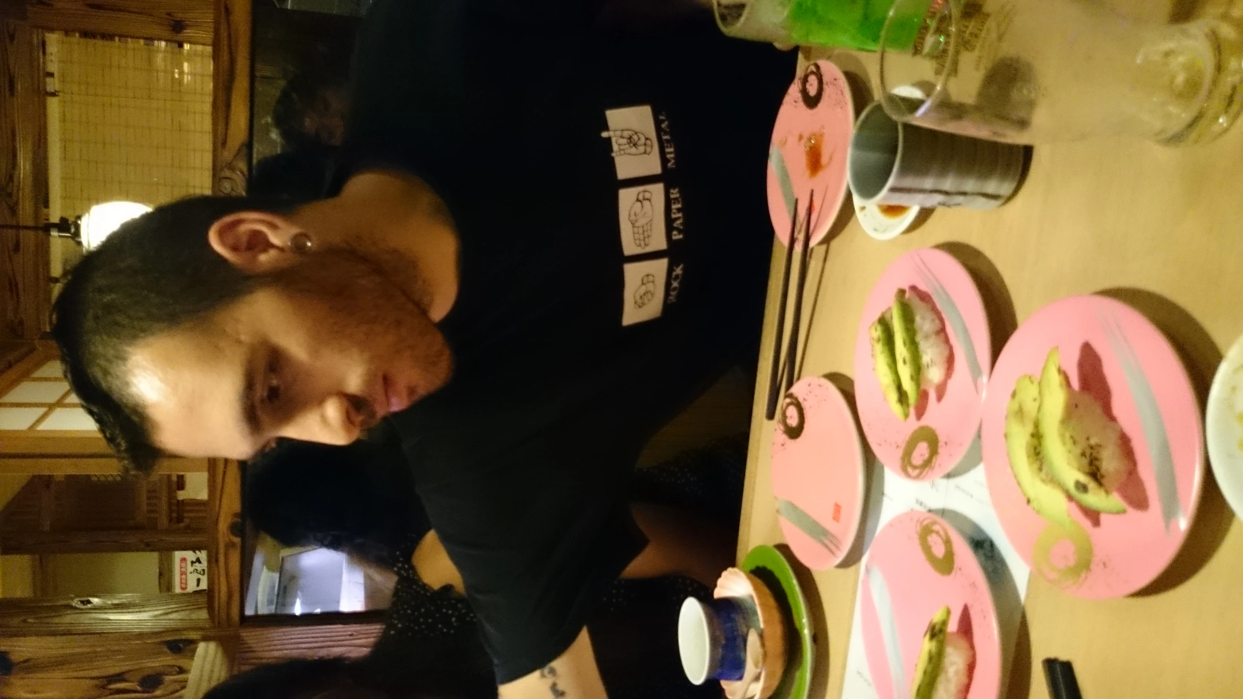 the young man is sitting at the table with several plates of food