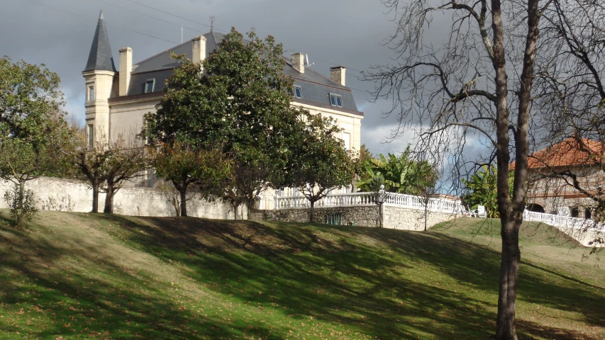 a view of an old building behind a tree