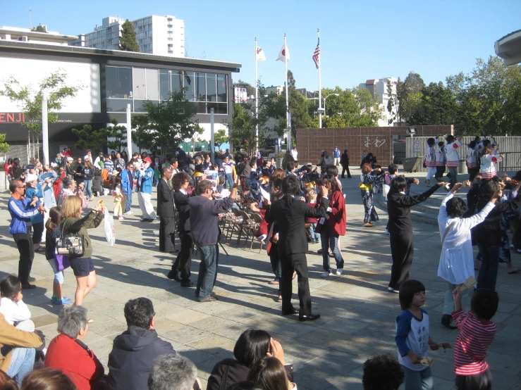 a crowd of people at a public plaza