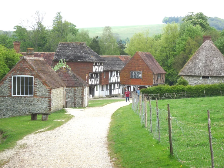 an old village with a couple of windmills near the road