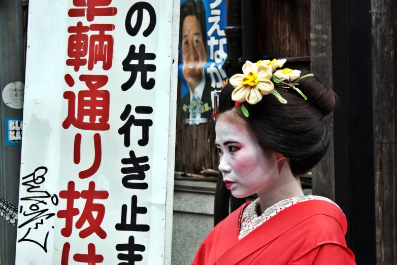 there is a woman with flowers in her hair walking past a sign