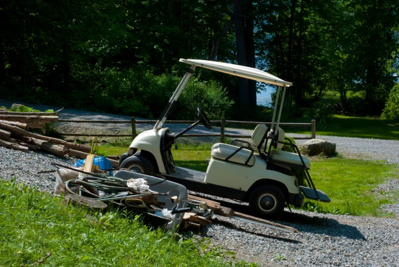 a golf cart that is sitting on some grass