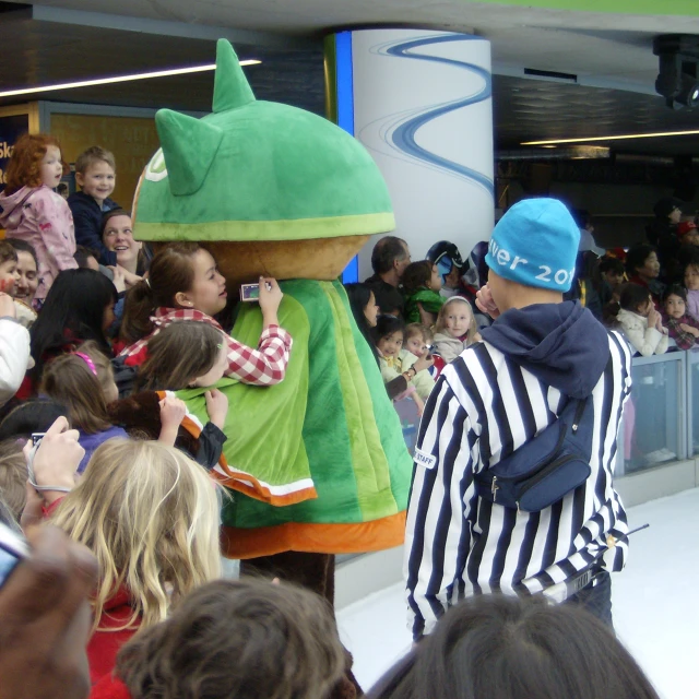 a costumed man standing on the runway with people watching