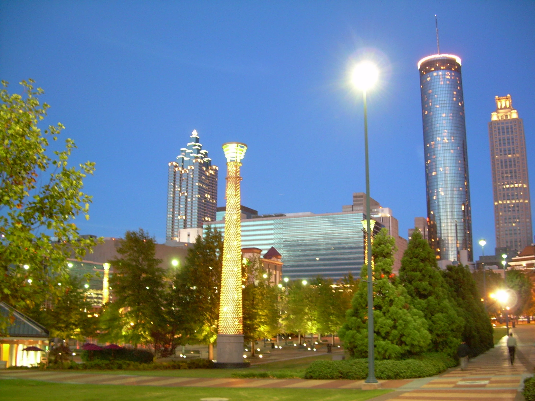 a street corner with a tall building at night