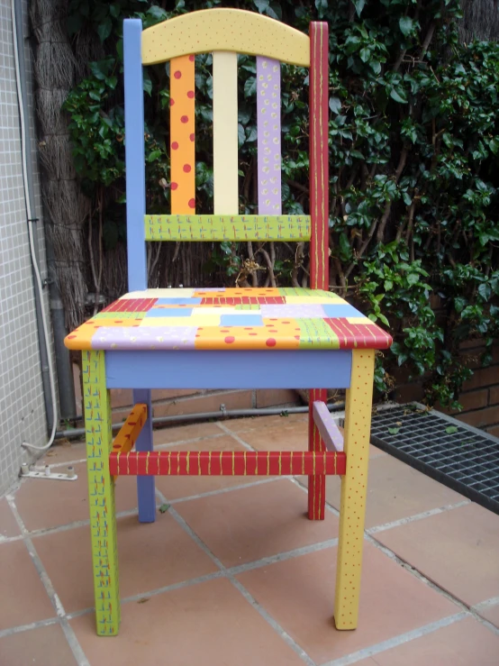 a multi - colored chair is decorated to look like a child's playroom